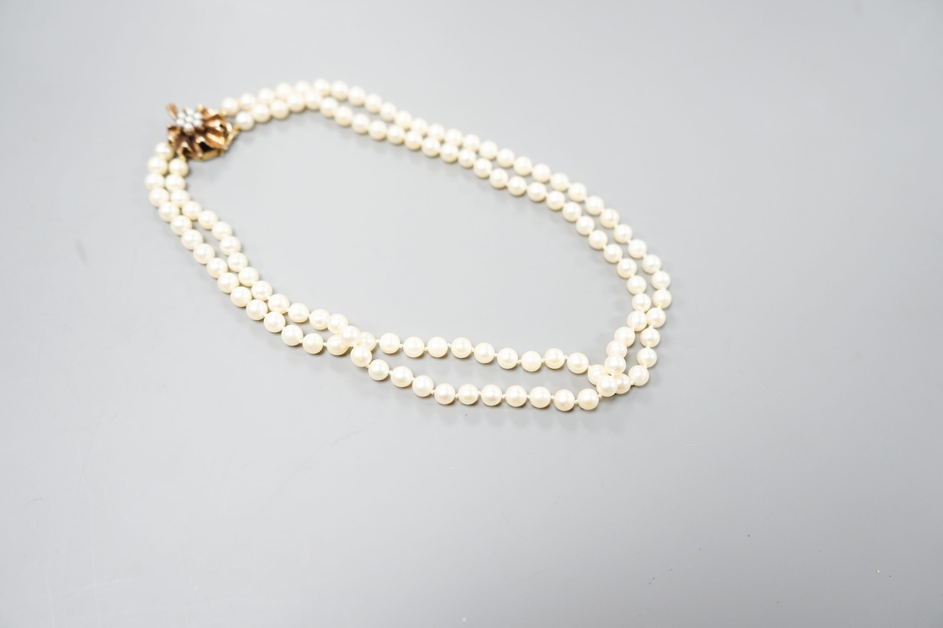 A double strand cultured pearl choker necklace, with cultured pearl set 9ct gold clasp, 38cm, with spare loose pearls.